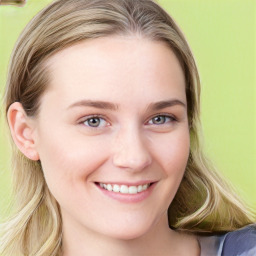 Joyful white young-adult female with long  brown hair and blue eyes