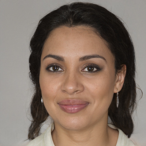 Joyful black adult female with medium  brown hair and brown eyes