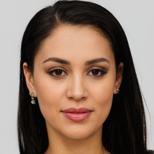 Joyful latino young-adult female with long  brown hair and brown eyes