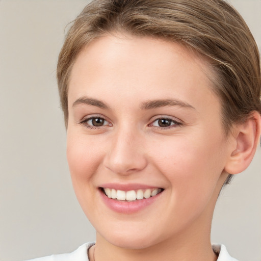 Joyful white young-adult female with short  brown hair and brown eyes