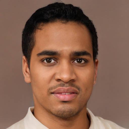 Joyful latino young-adult male with short  brown hair and brown eyes