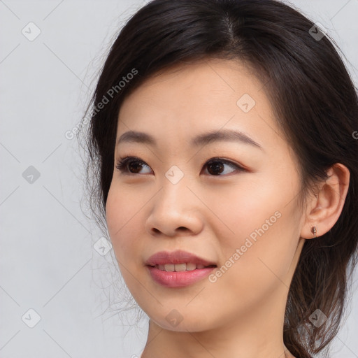 Joyful asian young-adult female with long  brown hair and brown eyes