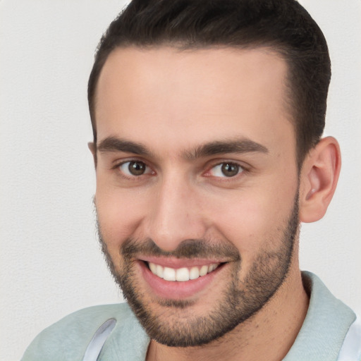 Joyful white young-adult male with short  brown hair and brown eyes