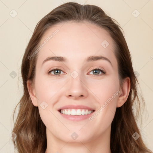 Joyful white young-adult female with long  brown hair and blue eyes