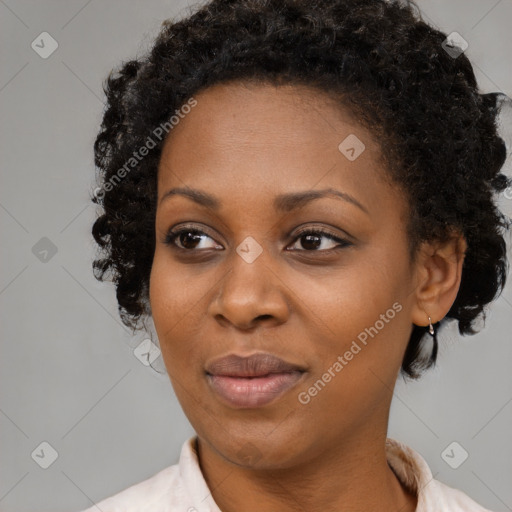 Joyful black adult female with short  brown hair and brown eyes