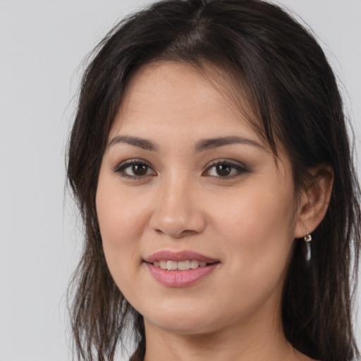 Joyful white young-adult female with long  brown hair and brown eyes