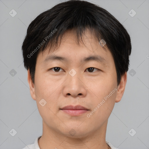 Joyful asian young-adult male with short  brown hair and brown eyes