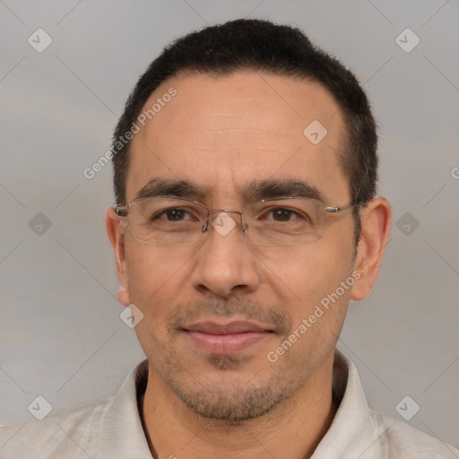 Joyful white adult male with short  black hair and brown eyes