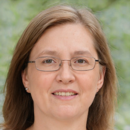 Joyful white adult female with medium  brown hair and blue eyes