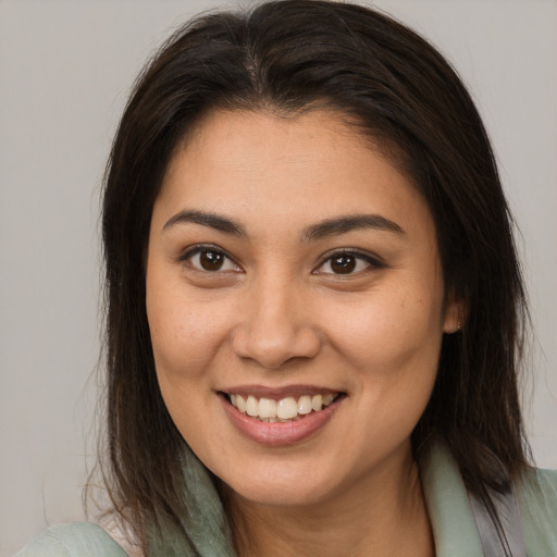 Joyful white young-adult female with medium  brown hair and brown eyes