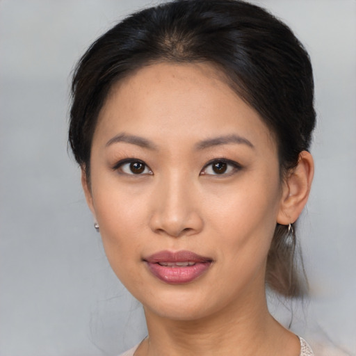 Joyful asian young-adult female with medium  brown hair and brown eyes