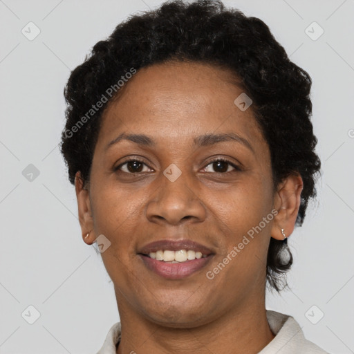 Joyful black adult female with short  brown hair and brown eyes