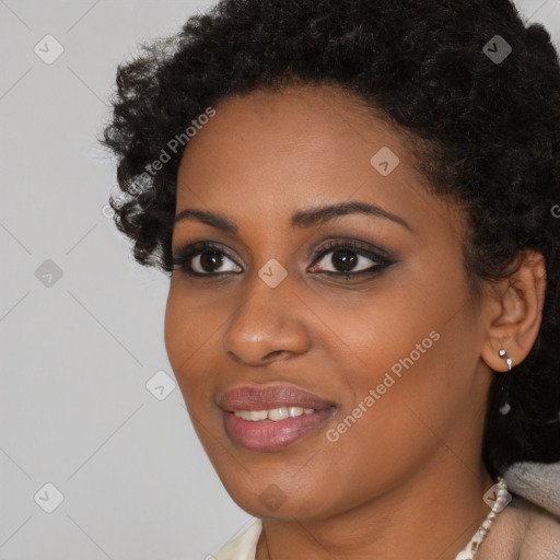 Joyful black young-adult female with short  black hair and brown eyes