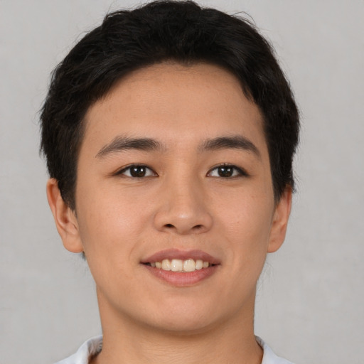 Joyful asian young-adult male with short  brown hair and brown eyes
