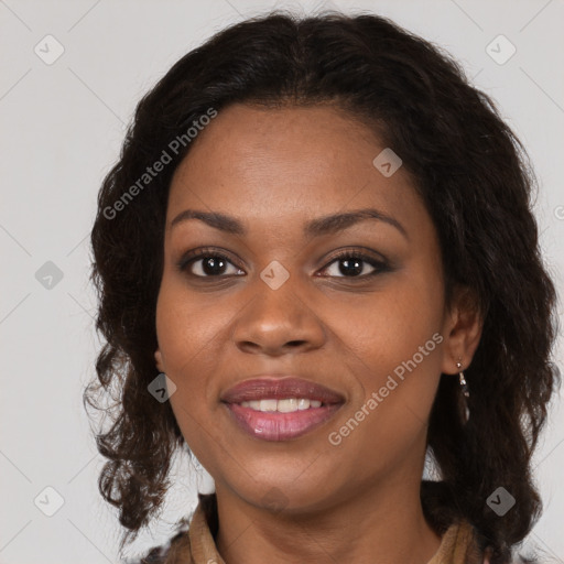 Joyful black adult female with medium  brown hair and brown eyes