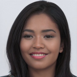 Joyful latino young-adult female with long  black hair and brown eyes
