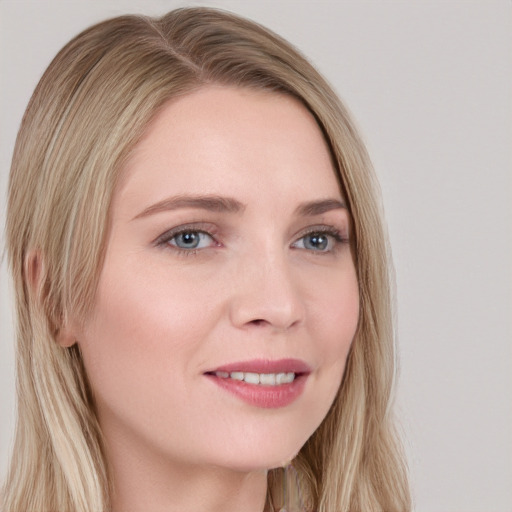 Joyful white young-adult female with long  blond hair and blue eyes