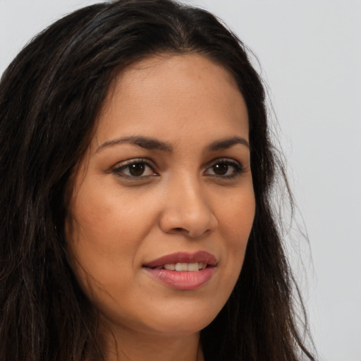 Joyful latino young-adult female with long  brown hair and brown eyes
