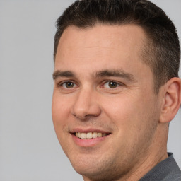 Joyful white young-adult male with short  brown hair and brown eyes