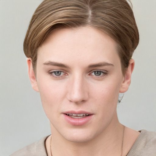 Joyful white young-adult female with short  brown hair and grey eyes