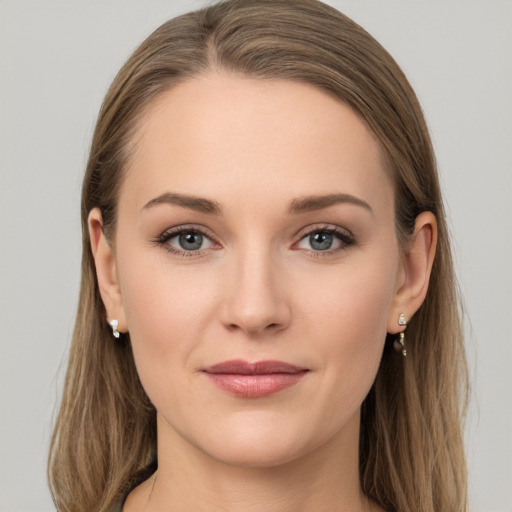 Joyful white young-adult female with long  brown hair and grey eyes