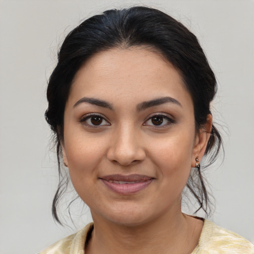Joyful latino young-adult female with medium  brown hair and brown eyes