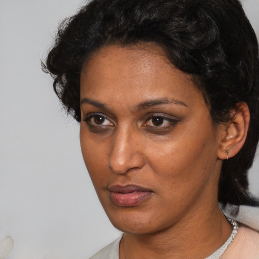Neutral latino adult female with short  brown hair and brown eyes