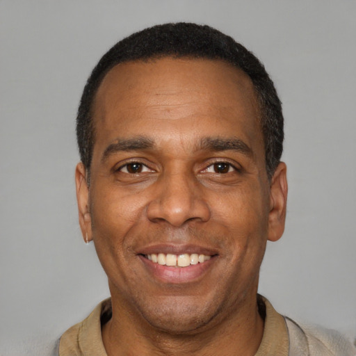 Joyful latino adult male with short  black hair and brown eyes