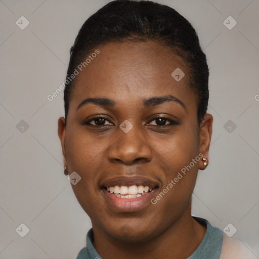 Joyful black young-adult female with short  black hair and brown eyes