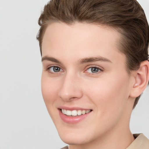 Joyful white young-adult female with short  brown hair and grey eyes