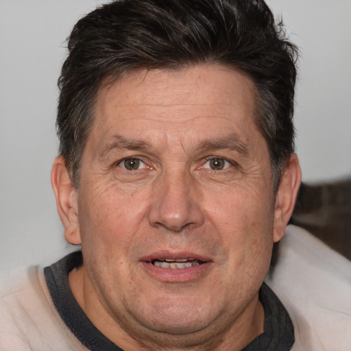 Joyful white middle-aged male with short  brown hair and brown eyes