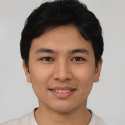 Joyful asian young-adult male with short  black hair and brown eyes