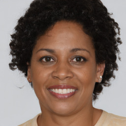 Joyful black adult female with short  brown hair and brown eyes