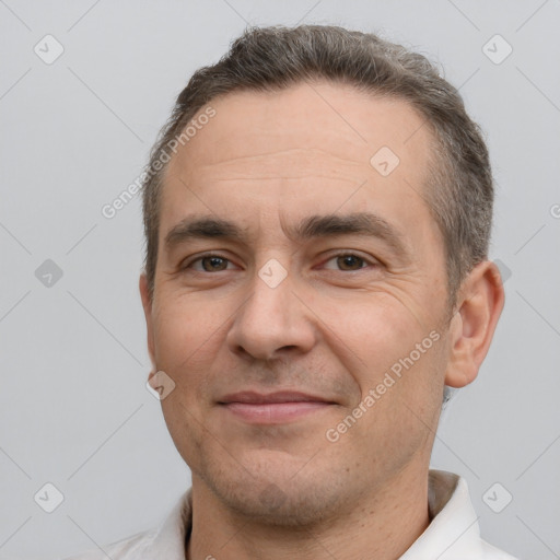 Joyful white adult male with short  brown hair and brown eyes