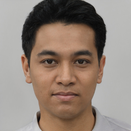 Joyful asian young-adult male with short  black hair and brown eyes