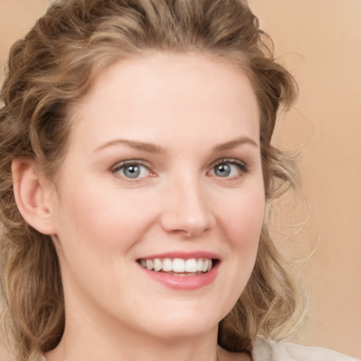 Joyful white young-adult female with medium  brown hair and blue eyes