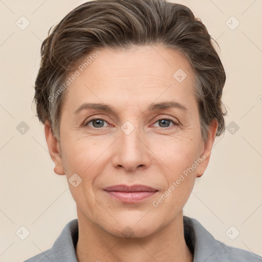 Joyful white adult female with short  brown hair and brown eyes