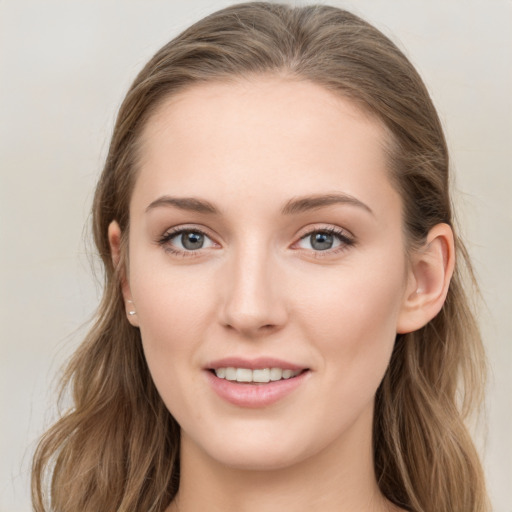 Joyful white young-adult female with long  brown hair and blue eyes