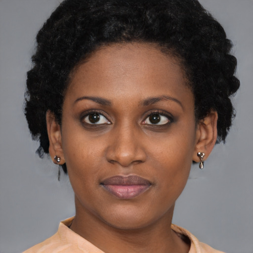 Joyful black young-adult female with short  brown hair and brown eyes