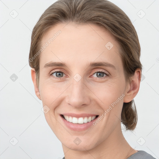 Joyful white young-adult female with short  brown hair and grey eyes