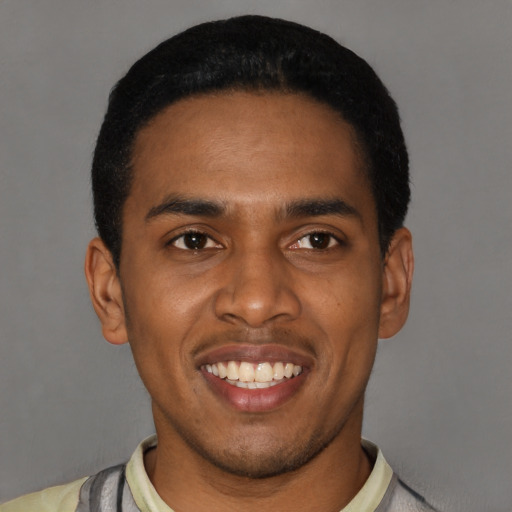 Joyful latino young-adult male with short  black hair and brown eyes
