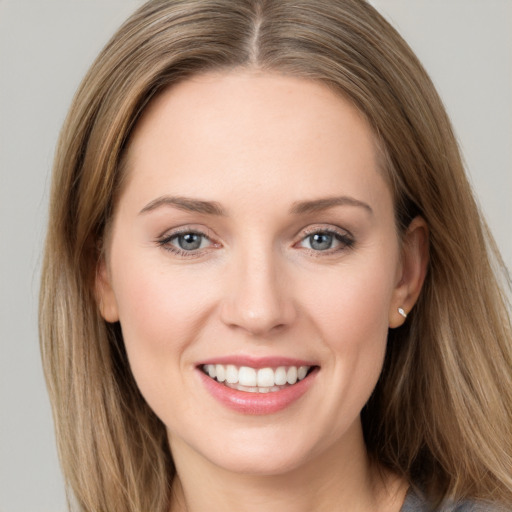 Joyful white young-adult female with long  brown hair and grey eyes