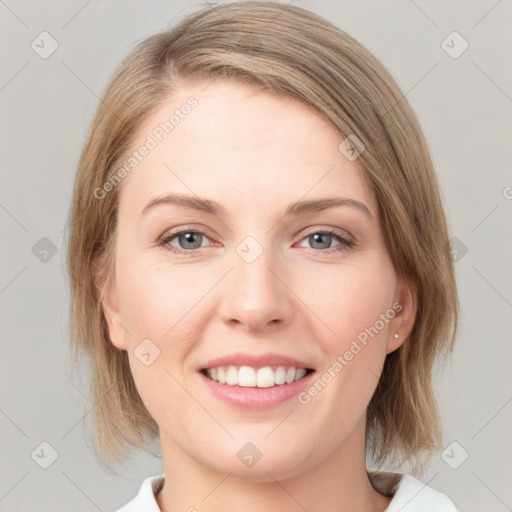 Joyful white young-adult female with medium  brown hair and blue eyes