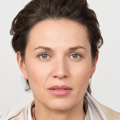 Joyful white adult female with short  brown hair and grey eyes