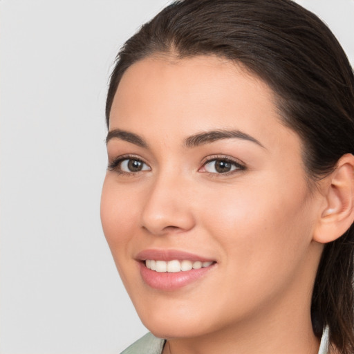 Joyful white young-adult female with medium  brown hair and brown eyes