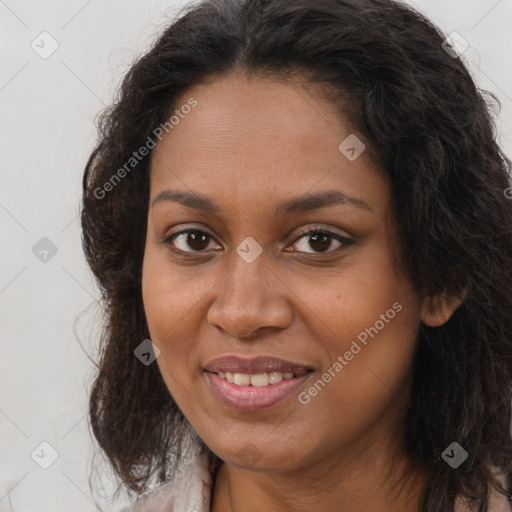 Joyful black young-adult female with long  brown hair and brown eyes