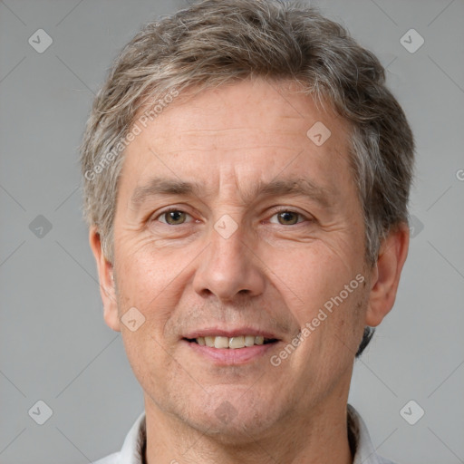 Joyful white middle-aged male with short  brown hair and brown eyes