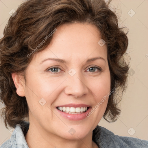 Joyful white adult female with medium  brown hair and blue eyes