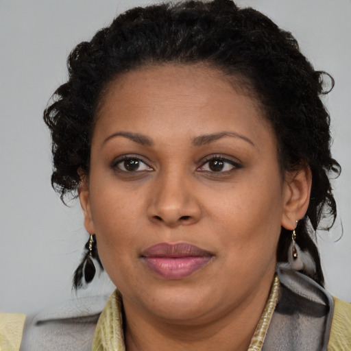 Joyful latino adult female with medium  brown hair and brown eyes