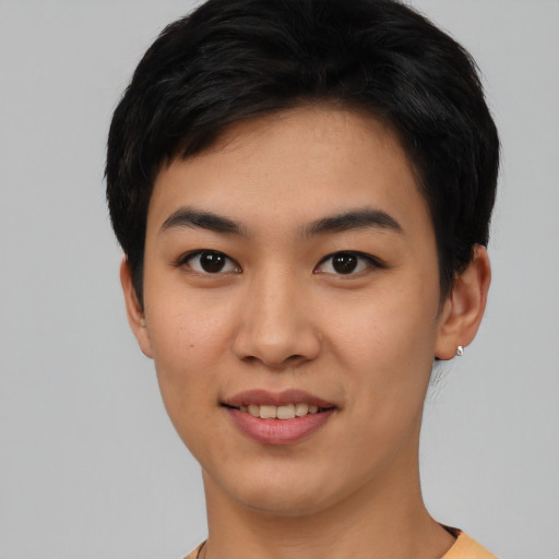 Joyful asian young-adult female with short  black hair and brown eyes